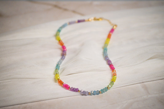 Colorful beaded necklace on a light quartz surface