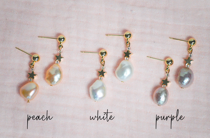 Set of pearl earrings with gold accents on a pink background, labeled 'purple', 'white', and 'peach'.
