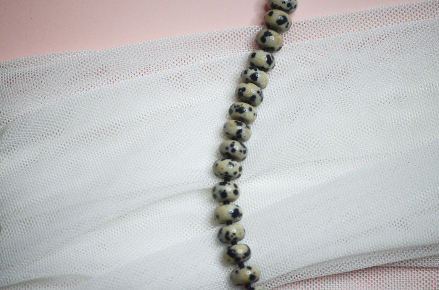 Beaded necklace on a textured fabric surface