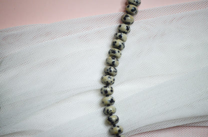 Beaded necklace on a textured fabric surface
