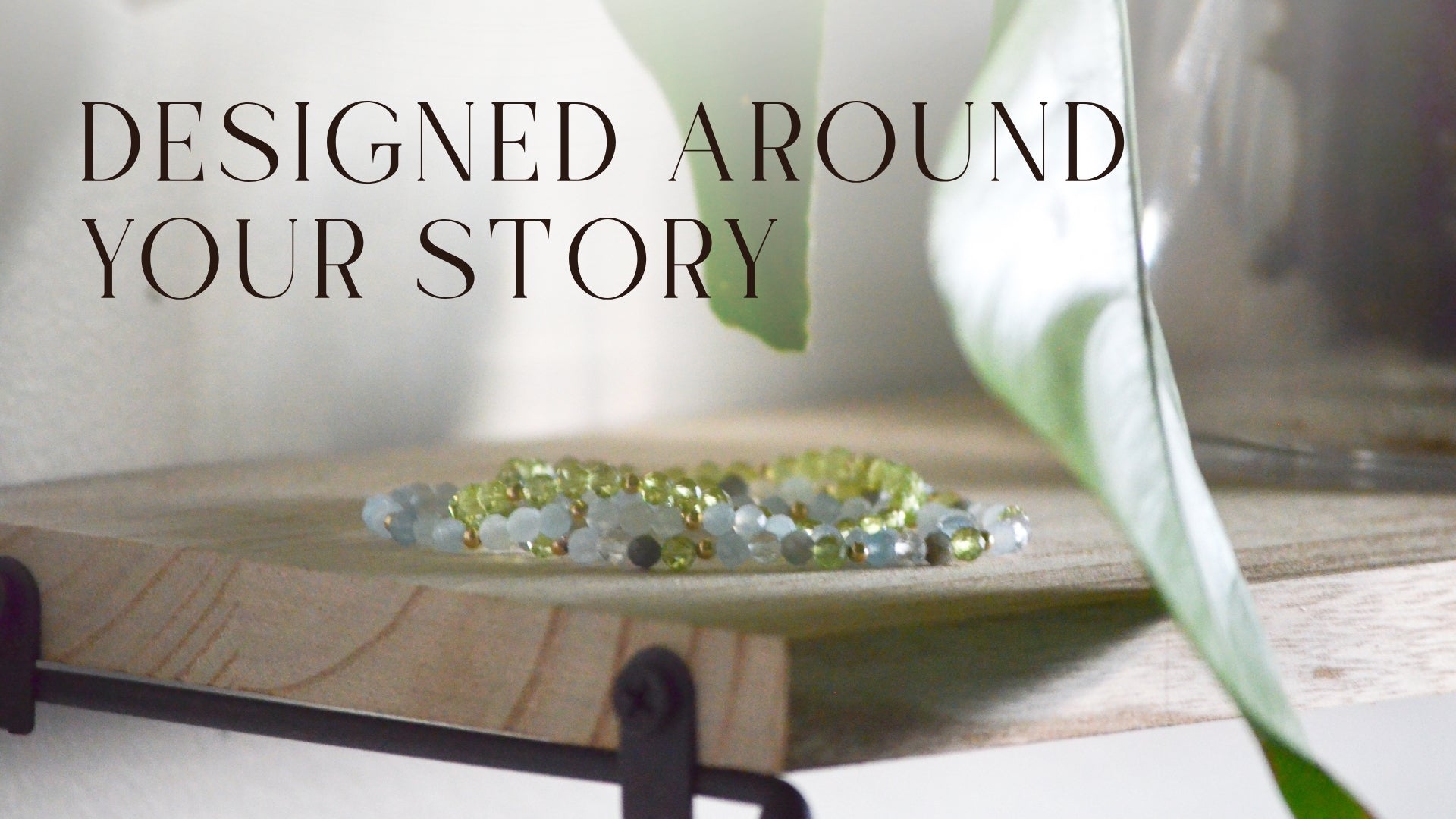 three beaded necklaces on a table with the text "Designed around your story"