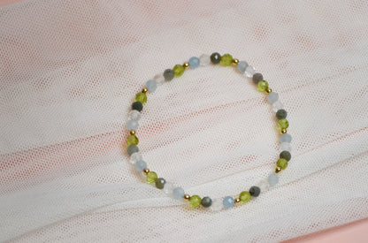 Beaded birthstone bracelet on a white fabric background