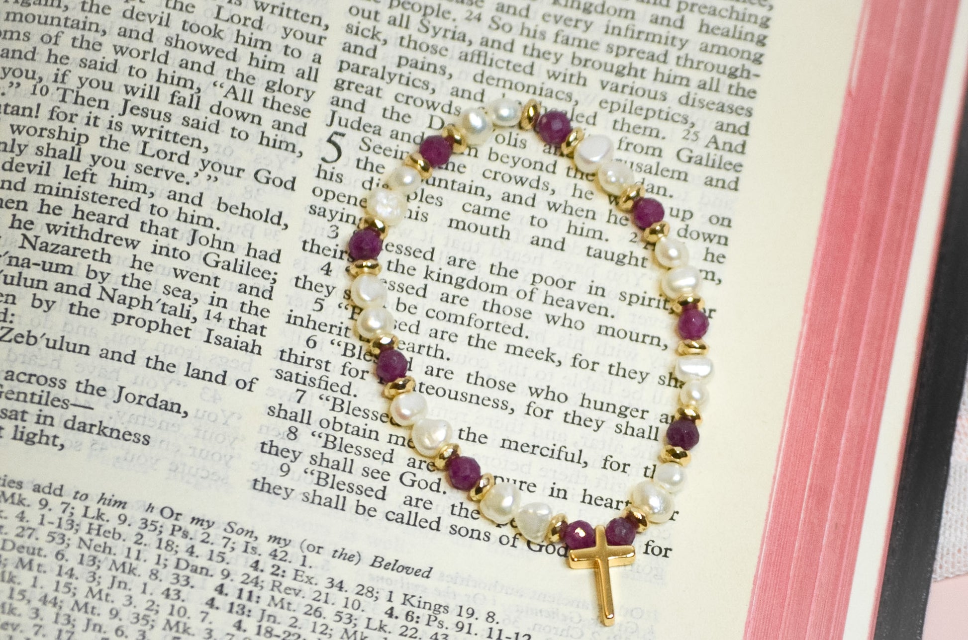 Bracelet with beads and a cross on an open bible