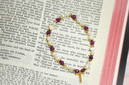 Bracelet with beads and a cross on an open bible