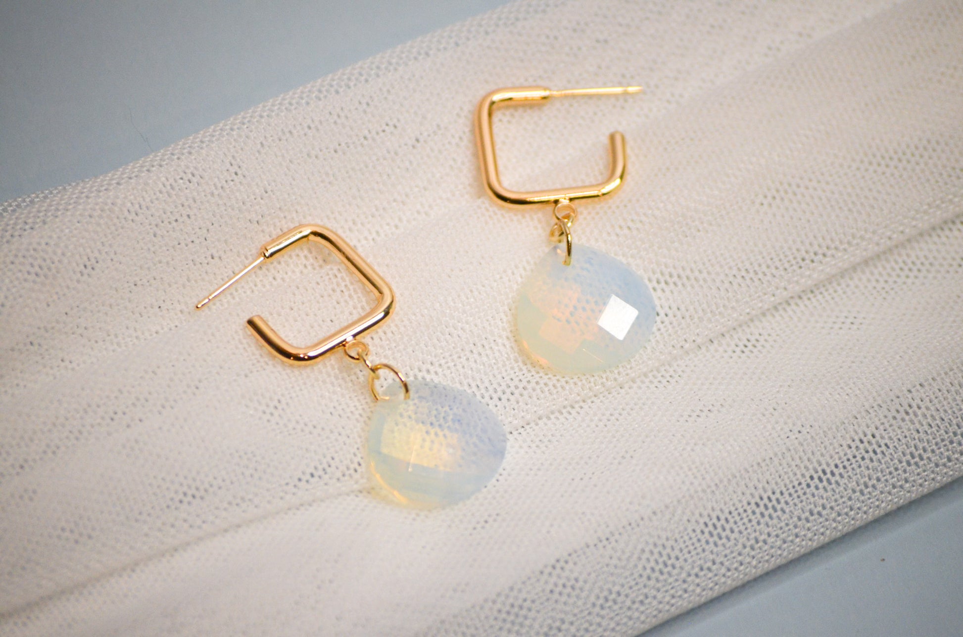 Gold square hoop dangle earrings with teardrop iridescent gemstone pendants