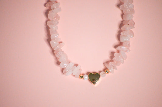 Necklace with heart-shaped pendant on a pink background
